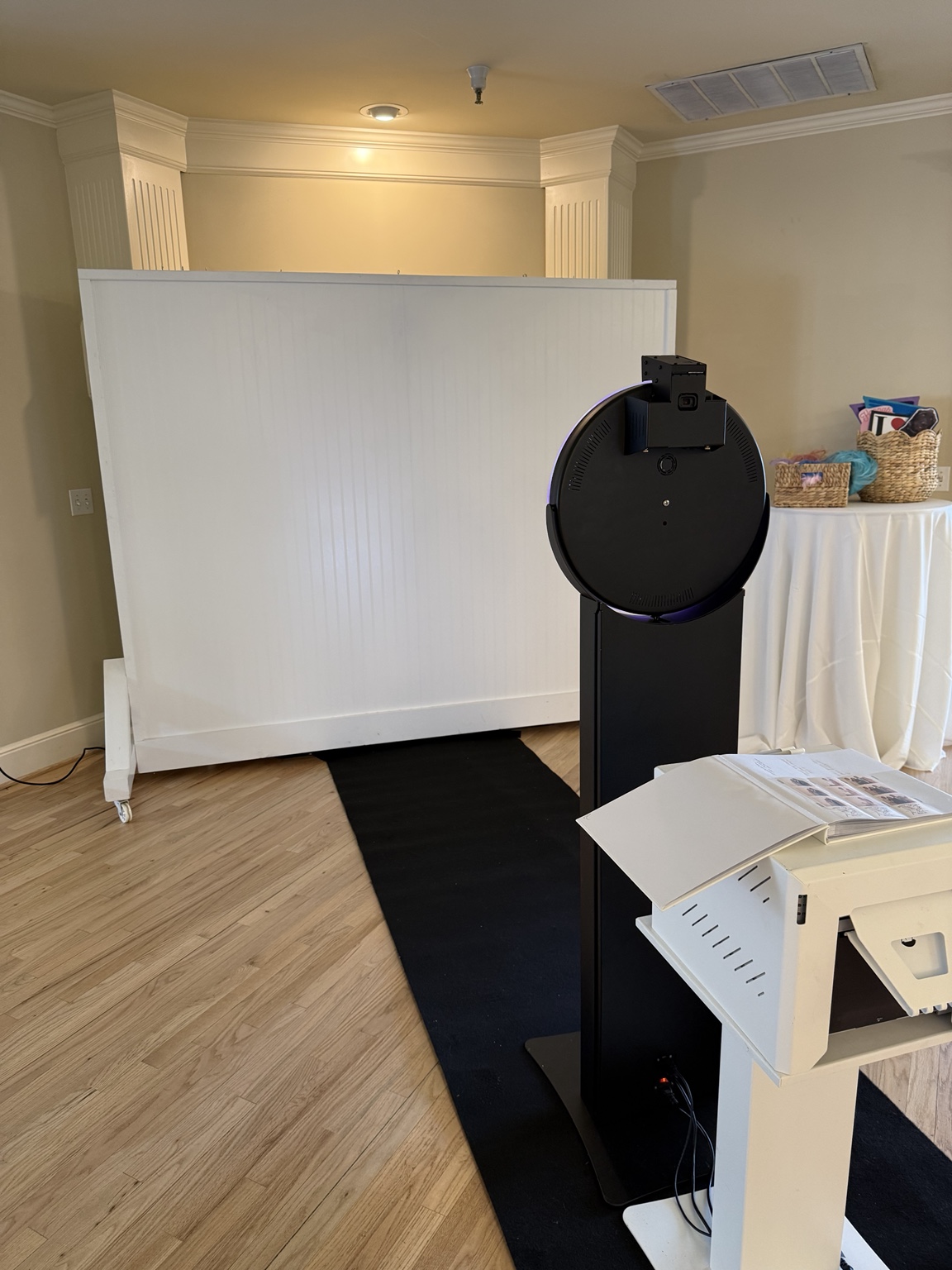Photo booth setup with printer, backdrop and props